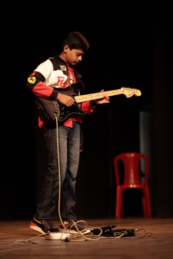 Child playing a musical instrument — Instrumental Genius category
