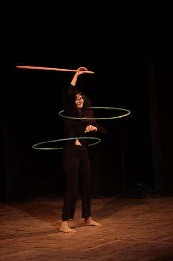 Child performing a hula hoop act on stage at WKC Showcases